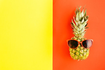 Top view pineapple in sunglasses on colorful background. Flat lay. Summer Background concept