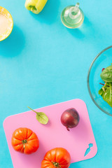 Frame from ingredients for cooking summer salad on blue background, top view. Healthy food concept