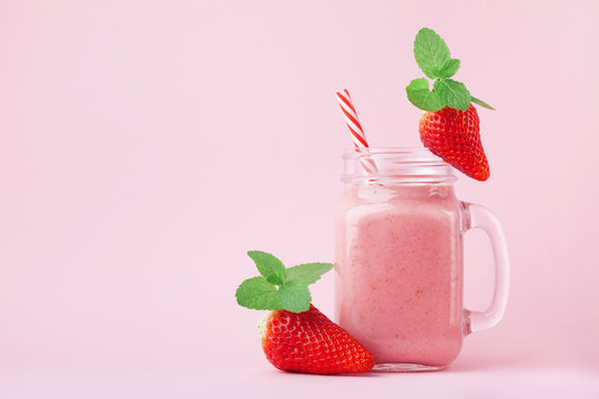 pink smoothie with wild cranberries in mason jar with mint and straw on  wooden background Stock Photo by nblxer