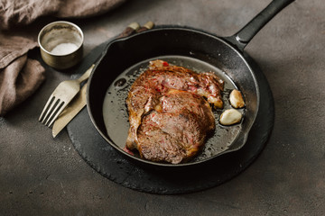 Juicy beef steak on a vintage cast-iron frying pan