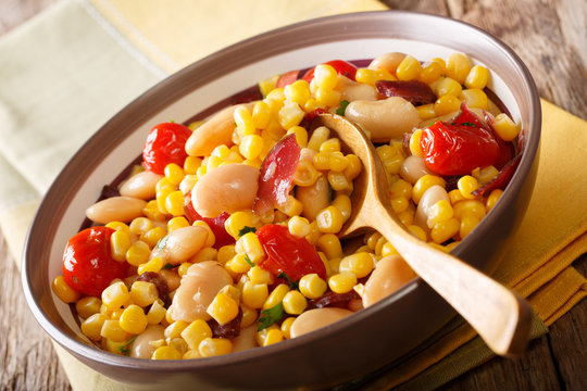 Salad of oil beans, tomatoes, peppers and bacon close-up in a bowl. succotash. horizontal