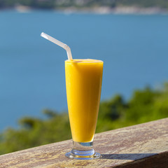 Fresh organic Mango shake in thai restaurant on the beach near sea , Thailand. Close up