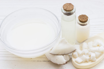 Natural herbal skin care products, top view ingredients coconut, essence oil on table concept of the best all natural face moisturizer. Facial treatment preparation background