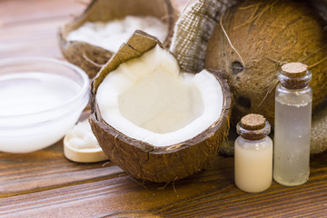 Natural herbal skin care products, top view ingredients coconut, essence oil on table concept of the best all natural face moisturizer. Facial treatment preparation background