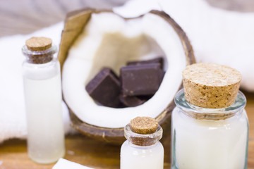 Natural herbal skin care products, top view ingredients coconut, essence oil on table concept of the best all natural face moisturizer. Facial treatment preparation background