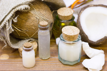 Natural herbal skin care products, top view ingredients coconut, essence oil on table concept of the best all natural face moisturizer. Facial treatment preparation background