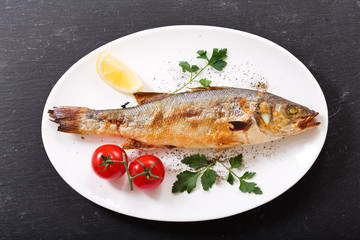 plate of baked fish with vegetables