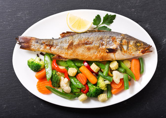 plate of baked fish with vegetables