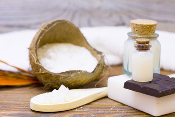 Natural herbal skin care products, top view ingredients coconut, essence oil on table concept of the best all natural face moisturizer. Facial treatment preparation background