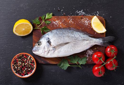 fresh fish dorado with ingredients for cooking