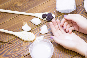 Natural herbal skin care products, top view ingredients coconut, hands on table concept of the best all natural face moisturizer. Facial treatment preparation background