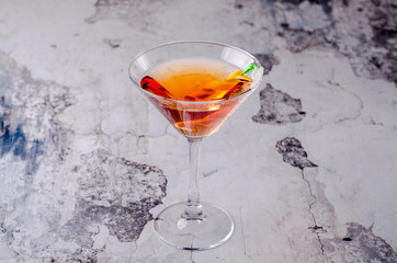 Top view red orange cocktail Margarita fresh in a martini glass on a gray background. Bar alcohol drink menu, delicious tequila sunrise long drink.