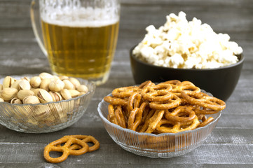Beer with snacks on a wooden background.