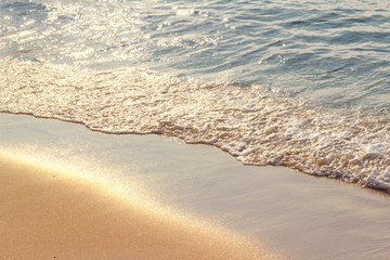 Sea waves hit the beach,Light falls on the surface of the sea,Beach with sunlight