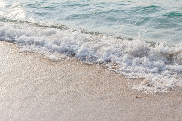 Sea waves hit the beach,Light falls on the surface of the sea,Beach with sunlight