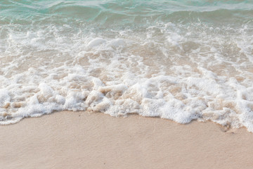 Fototapeta na wymiar Sea waves hit the beach,Light falls on the surface of the sea,Beach with sunlight