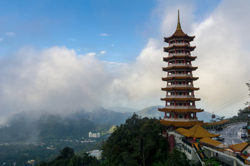 The Chin Swee Caves Temple over clouds and heavy fog. The temple is situated in the most scenic...