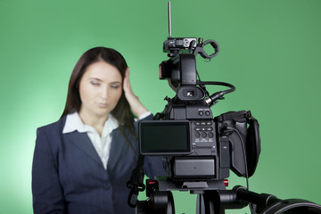 Blur image. Television announcer at studio isolated on a green background. Video recording news