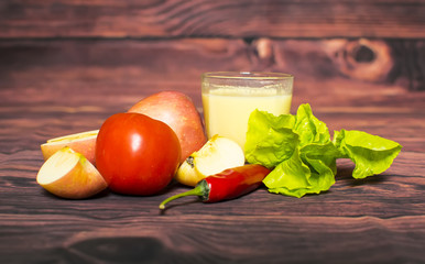 Fresh corn milk and tomato, apple, chili on wooden table, closeup