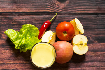 Fresh corn milk and tomato, apple, chili on wooden table, closeup