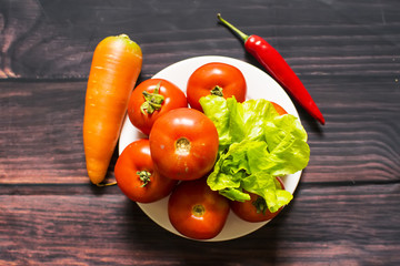 Close-up of fresh, ripe tomatoes on wood background