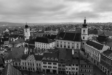 Fototapeta na wymiar Sibiu Council Tower and Holy Trinity Roman Catholic Church viewed from the Evangelical Church