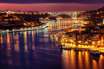 Fototapeta na wymiar View to Porto over river Douro with reflection of the lights at night