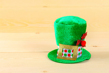 A green hat on a wooden table. St.Patrick 's Day.