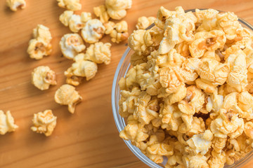 Selective focus Popcorn on wooden table.