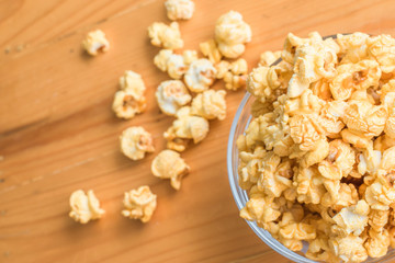 Selective focus Popcorn on wooden table.