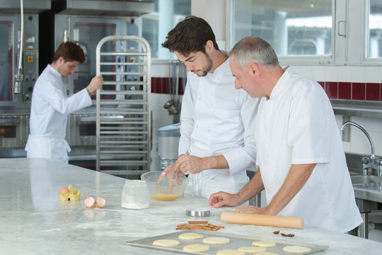 baker working with apprentice