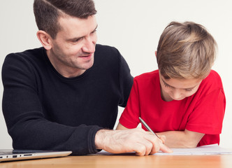 Fototapeta na wymiar father helping his son with homework
