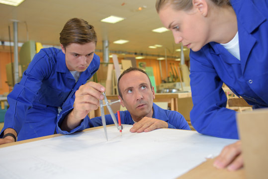 Trainees watching tutor using compass