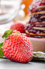 Pancakes strawberry, sugar and jam