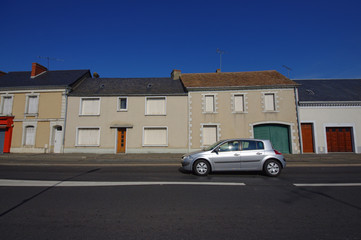 car driving through the houses and street
