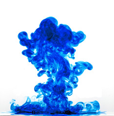Blue ink in water against a white background.