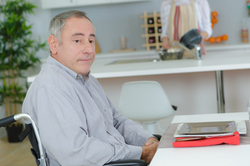 man in a wheelchair working on a laptop