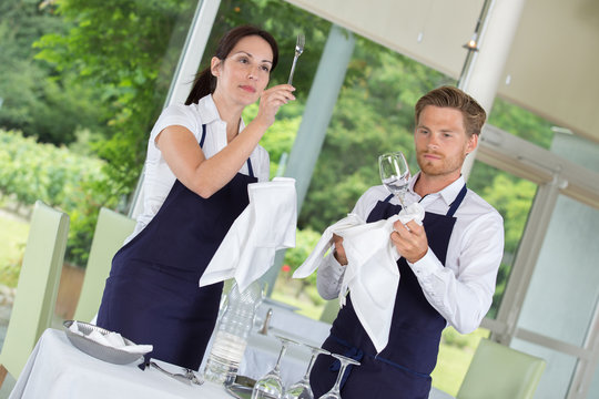 waiters setting the tables at gastronomy restaurant