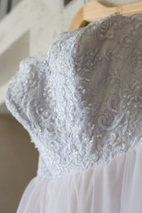 Fototapeta na wymiar Pinl and white wedding dress, closeup