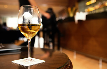 a glass of white wine on a table