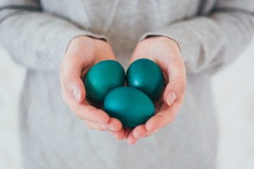 Beautiful woman hands holden blue easter egg with perfect nails can be used as background