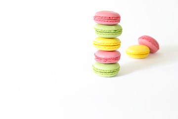 Three different types of macaroons colors pink, green and yellow isolated on white background.