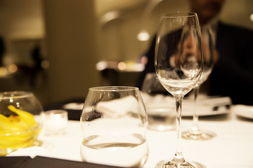 empty glasses for wine and water on a table in a restaurant