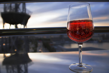 a glass of red wine on the balcony in the evening