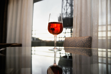 a glass of red wine on the table in the room
