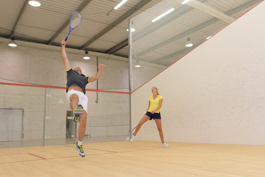 couple playing tennis game indoori in tennis court