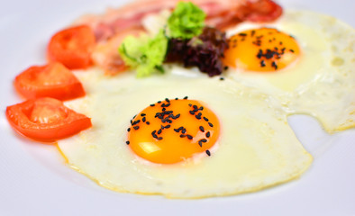 Restaurant fried eggs with bacon and tomatoes. Morning breakfast.