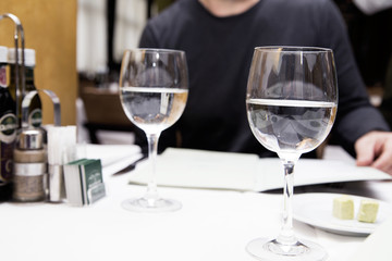 two glasses of water on a table in a restaurant
