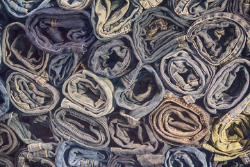Lot of different blue jeans close-up