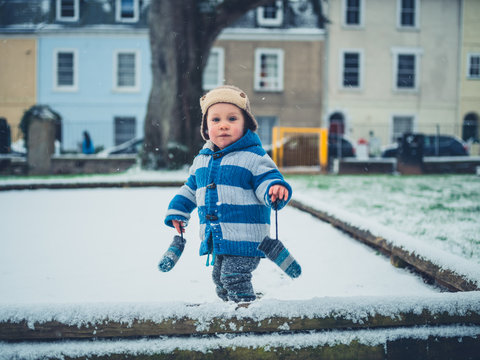 Toddler on a playground in the snow